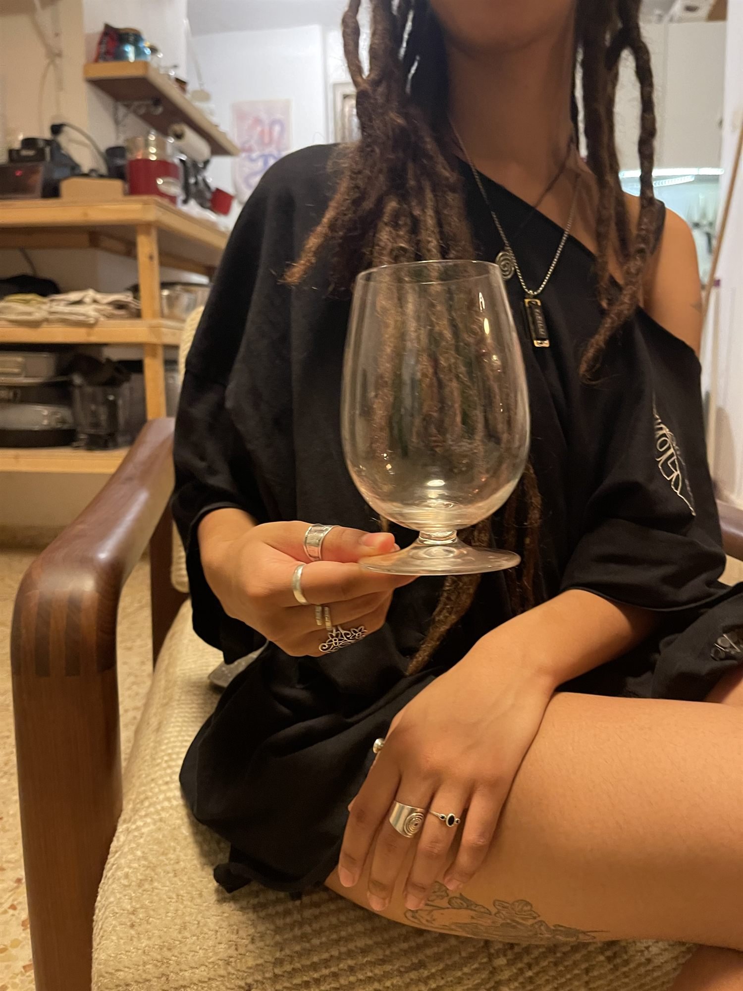 The glass held in one hand